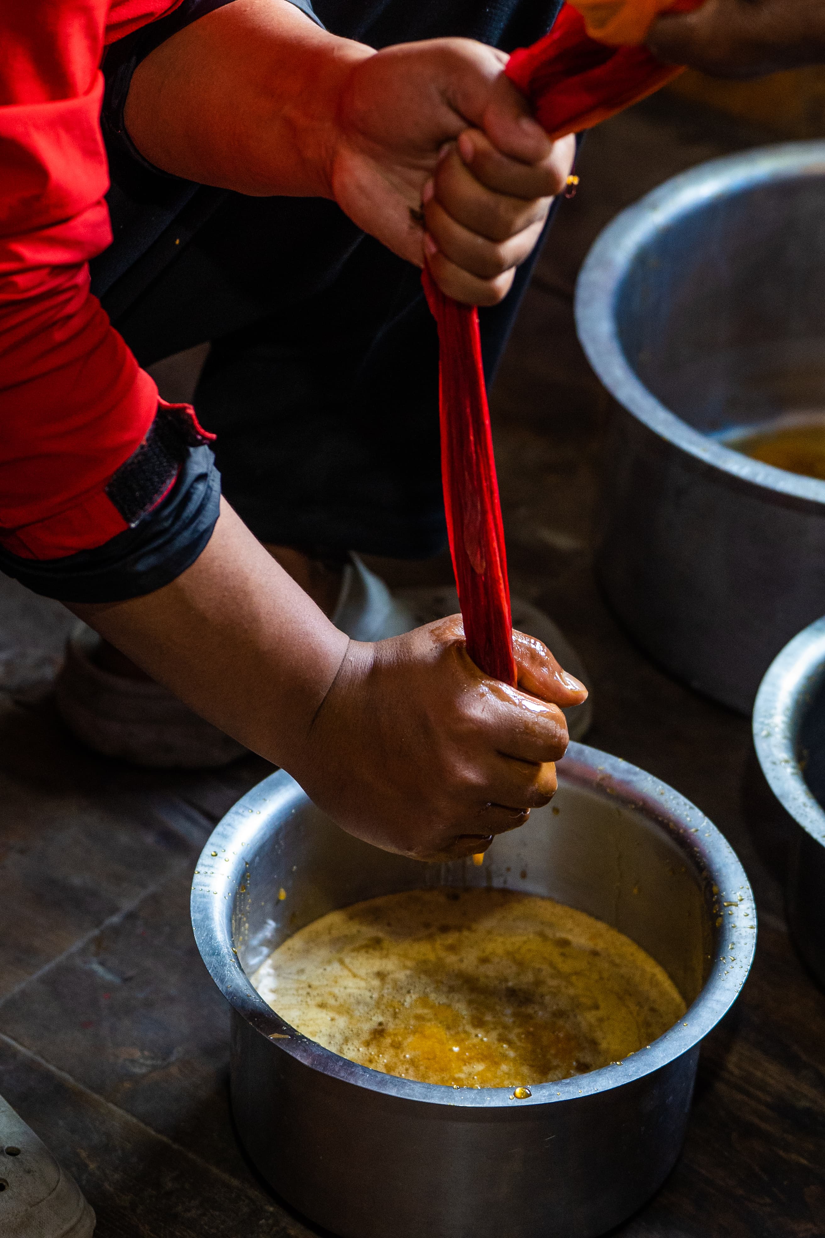 Straining the harvest by hand before it's bottled